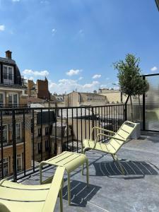 two yellow chairs sitting on top of a roof at New Hotel Op&eacute;ra in Paris