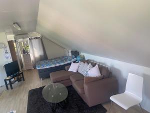 a living room with a couch and a bed at Gäst lägenheten med egen terrass in Falkenberg