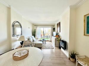 a living room with a table and a couch at Simply Astonishing Location in Benalmádena