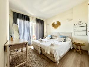 a bedroom with a large bed and a window at Simply Astonishing Location in Benalmádena +43 photos