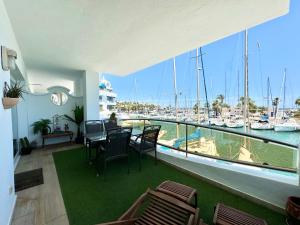 a room with a balcony with a view of a marina at Simply Astonishing Location in Benalmádena