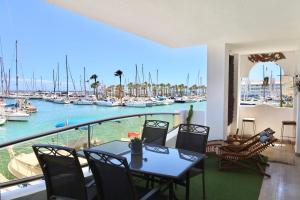 a balcony with a table and chairs and a marina at Simply Astonishing Location in Benalmádena