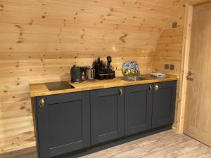 a kitchen with a counter and a sink in a cabin at The Glen Lodge in Auckingill