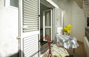 a balcony with an open door and an umbrella at White Hill Studio-Apartments in Makarska