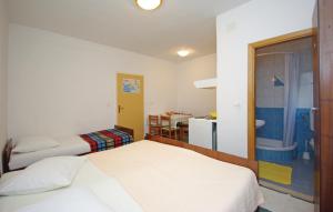 a small bedroom with two beds and a bathroom at White Hill Studio-Apartments in Makarska