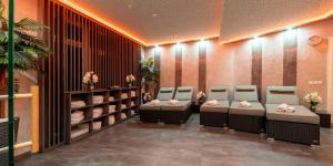 a waiting room with chairs and flowers at PLAZA Residence Stuttgart-Ditzingen in Ditzingen
