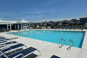 a large swimming pool with lounge chairs and condos at Marlin Chase --- 30266 Kona Dr in Ocean View