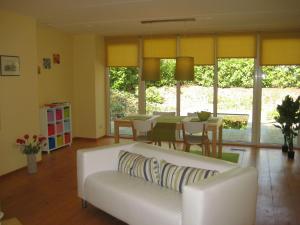 a living room with a white couch and a table at Holiday Home 2-1 by Interhome in Lochem