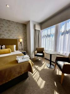 费利克斯托Hotel Coco的一间配有床、桌子和椅子的酒店房间
