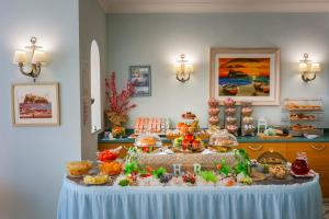 a table with a buffet of food on it at Hotel Rivamare in Ischia