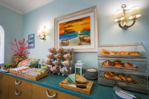 a bakery with bread and pastries on a counter at Hotel Rivamare in Ischia