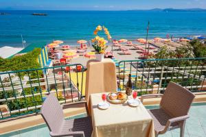 a balcony with a table and chairs and the ocean at Hotel Rivamare in Ischia
