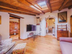a living room with a couch and a tv at Apartment Ciliegiolo by Interhome in Castiglione Chiavarese