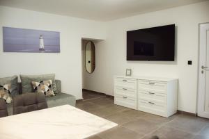 a living room with a couch and a tv at Apartments Petra in Risika