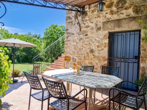 a table and chairs on the patio of a house at Holiday Home La maison aux volets bleus by Interhome in Entrecasteaux +38 photos