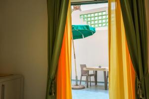 a room with a table and a colorful curtain at Hotel Rivamare in Ischia