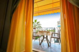 a view of a balcony with a table and chairs at Hotel Rivamare in Ischia
