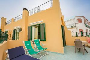 a couple of chairs and a table on a patio at Hotel Rivamare in Ischia
