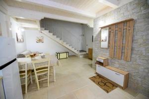 a kitchen and dining room with a table and a staircase at La Chicca nel Centro in Massafra +12 photos