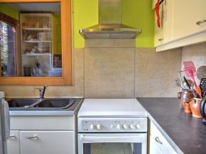 a kitchen with a white stove and a sink at Chalet cosy à Morzine, proche navettes, avec garage, terrasse et équipements complets - FR-1-524-13 in Morzine