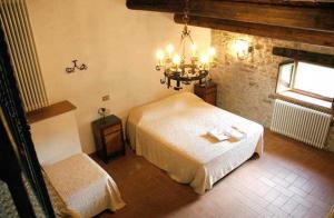 a bedroom with a white bed and a window at Agriturismo Il Casalone in Badia Tedalda +20 photos