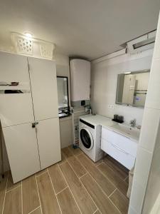 a kitchen with a washing machine and a sink at Studio thalie in Bormes-les-Mimosas
