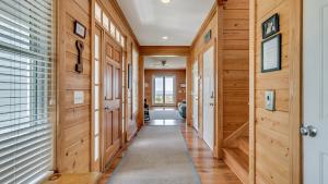 a hallway in a house with wooden walls at Mr, Bugs Summer House home by Peace Vacations in Pawleys Island +21 photos