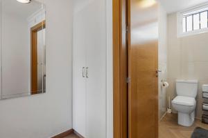 La salle de bains est pourvue de toilettes et d'une porte en verre. dans l'établissement Sunny apartment in the Center, 5 min. from the Beach, à Fuengirola 21 autres photos