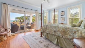 a bedroom with a bed and a balcony at Blue Dolphin home by Peace Vacations in Georgetown