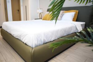 Ένα ή περισσότερα κρεβάτια σε δωμάτιο στο Gracey Concierge Apartments - Avenue Uvira