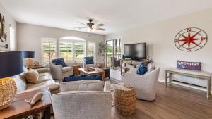 a living room filled with furniture and a flat screen tv at 55C Anchors Away II at True Blue condo by Peace Vacations in Pawleys Island