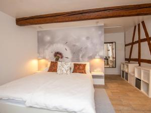 a bedroom with a large white bed and a wall at Apartment Eliese by Interhome in Suhl