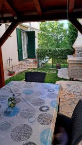 a table with a table cloth on a patio at Apartman Seaside in Vantačići