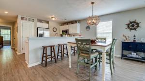 a kitchen and dining room with a table and chairs at 55C Anchors Away at True Blue condo by Peace Vacations in Pawleys Island +22 photos
