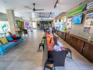 a lobby of a restaurant with a counter and chairs at Mad Monkey Hoi An in Hoi An