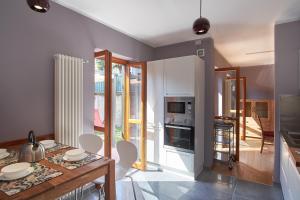 a kitchen and dining room with a table and chairs at Il Borghetto Villa Pallante - Villa with Private Garden and Access to Swimming Pool in Cissano