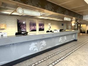 a restaurant with a long counter in a building at Sojourn Suites Portland Airport in Portland