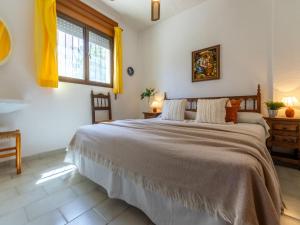 a bedroom with a large bed and a window at Holiday Home Reca by Interhome in L'Ampolla