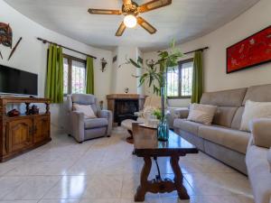 a living room with a couch and a ceiling fan at Holiday Home Reca by Interhome in L'Ampolla