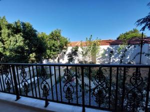 a balcony with a black fence and trees at Blue Bay Hotel in Iraklitsa