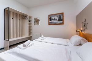 Łóżko lub łóżka w pokoju w obiekcie Alm Appartements ZellamSee