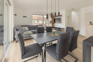 a dining room and living room with a table and chairs at Apartment Božica in Ljubljana +20 photos
