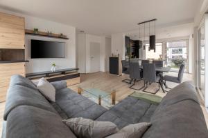 a living room with a couch and a dining room at Apartment Božica in Ljubljana