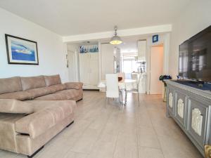 a living room with a couch and a flat screen tv at Apartment Formentor by Interhome in Salou