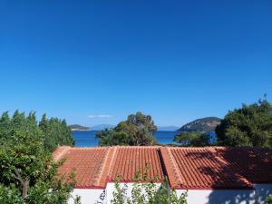 a view of the roofs of houses and the ocean at Blue Bay Hotel in Iraklitsa
