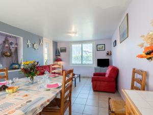 a dining room and living room with a table and chairs at Holiday Home Villa la Fourmi by Interhome in Saint-Germain-sur-Ay