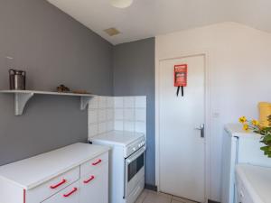 a kitchen with a white refrigerator and a white dishwasher at Holiday Home Villa la Fourmi by Interhome in Saint-Germain-sur-Ay