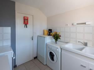 a kitchen with a washing machine and a sink at Holiday Home Villa la Fourmi by Interhome in Saint-Germain-sur-Ay +11 photos