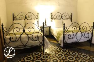a bedroom with two beds with white pillows at Hotel Layseca in San Juan del R&iacute;o