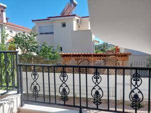 a black fence in front of a building at Blue Bay Hotel in Iraklitsa